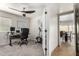 Home office space with a desk, exercise equipment, and good natural light with a view into the dining room at 3358 W Sandra Ter, Phoenix, AZ 85053