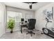 A home office space with a desk, computer, potted plant, exercise equipment, and good natural light at 3358 W Sandra Ter, Phoenix, AZ 85053