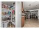 Walk-in pantry features ample storage shelves and easy access to the kitchen with tile flooring at 3358 W Sandra Ter, Phoenix, AZ 85053