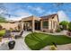 Inviting backyard features an expansive patio, putting green, and manicured desert landscaping at 3460 N Stone Gully St, Mesa, AZ 85207