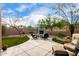 Serene backyard featuring a cozy seating area near an outdoor fireplace, landscaped accents, and manicured turf at 3460 N Stone Gully St, Mesa, AZ 85207