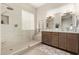 Bright bathroom featuring a glass enclosed shower, neutral color palette, and a double sink vanity with a quartz countertop at 3460 N Stone Gully St, Mesa, AZ 85207