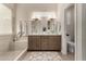 Dual sink bathroom with walk-in shower, linen closet, and modern vanity at 3460 N Stone Gully St, Mesa, AZ 85207