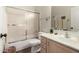 Compact bathroom with shower-tub, white toilet, sink with storage, bright lights and hardwood flooring for a clean look at 3460 N Stone Gully St, Mesa, AZ 85207