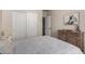 Relaxing bedroom with queen bed, neutral color scheme, closet and view into an open bathroom for added convenience at 3460 N Stone Gully St, Mesa, AZ 85207