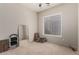 Minimalist bedroom with neutral walls, window, carpeted floor, mirror, and a folding bed for a cozy space at 3460 N Stone Gully St, Mesa, AZ 85207