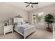 Bright bedroom features a ceiling fan, carpet flooring, and a large window at 3460 N Stone Gully St, Mesa, AZ 85207