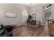 Dining area with wood floors, neutral walls, a vaulted ceiling, and an open floor plan at 3460 N Stone Gully St, Mesa, AZ 85207