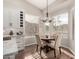 Bright breakfast nook features wood floors, a round table, and large windows with backyard views at 3460 N Stone Gully St, Mesa, AZ 85207