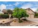 Charming desert home with desert landscaping, a three-car garage, and a rock water feature at 3460 N Stone Gully St, Mesa, AZ 85207