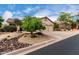 Single-story home with a three-car garage, desert landscaping, and a view from the side of the home at 3460 N Stone Gully St, Mesa, AZ 85207