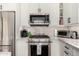Modern kitchen features stainless steel KitchenAid appliances and white shaker cabinets at 3460 N Stone Gully St, Mesa, AZ 85207