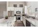 Modern kitchen featuring stainless steel appliances, white cabinets, and light granite countertops at 3460 N Stone Gully St, Mesa, AZ 85207