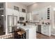 Bright kitchen features stainless steel appliances, white cabinets, and a large island with seating at 3460 N Stone Gully St, Mesa, AZ 85207