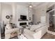 Open living room featuring neutral walls, wood floors, and a modern fireplace at 3460 N Stone Gully St, Mesa, AZ 85207