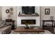 Living room featuring a shiplap fireplace, a ceiling fan, wood floors, and neutral paint at 3460 N Stone Gully St, Mesa, AZ 85207