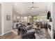 Spacious living room with a sliding door, wood floors, neutral walls, and an open floor plan at 3460 N Stone Gully St, Mesa, AZ 85207