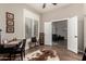 Open office space featuring a desk and bench seating that leads to a seating area beyond the double french doors at 3460 N Stone Gully St, Mesa, AZ 85207
