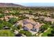 Aerial view of a home in a scenic community with mountain views and lush landscaping at 3521 N Hooper St, Buckeye, AZ 85396