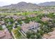 Beautiful aerial view of a grand home nestled in a community with lush greenery and scenic mountain backdrop at 3521 N Hooper St, Buckeye, AZ 85396