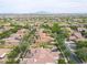 Aerial view of a neighborhood featuring homes, golf course, and surrounding mountains at 3521 N Hooper St, Buckeye, AZ 85396