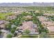 An aerial view of a neighborhood with mountain views, a golf course and well-maintained landscaping at 3521 N Hooper St, Buckeye, AZ 85396