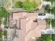 An aerial view showing the house with the brick patio, fire pit, landscaping, and the vehicle in the driveway at 3521 N Hooper St, Buckeye, AZ 85396