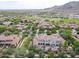 Stunning aerial view of a luxurious home in a well-manicured community, complete with mountain views at 3521 N Hooper St, Buckeye, AZ 85396