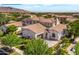 Aerial view of the property featuring a well-maintained lawn, trees, and landscape at 3521 N Hooper St, Buckeye, AZ 85396