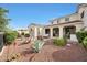 Expansive backyard featuring diverse desert landscaping, a covered patio, and an outdoor seating area at 3521 N Hooper St, Buckeye, AZ 85396