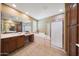 Bright bathroom featuring a soaking tub, glass enclosed shower, double vanity, and tiled floors at 3521 N Hooper St, Buckeye, AZ 85396