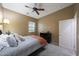 Bedroom featuring a queen bed, carpeted floors, neutral paint, ceiling fan, and a bright window at 3521 N Hooper St, Buckeye, AZ 85396