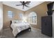 Bedroom featuring a queen bed, carpeted floors, neutral paint, ceiling fan, and a bright window at 3521 N Hooper St, Buckeye, AZ 85396