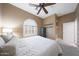 Bedroom featuring a queen bed, carpeted floors, neutral paint, ceiling fan, and a bright window at 3521 N Hooper St, Buckeye, AZ 85396