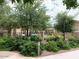 View of the community pool area with lush landscaping and black metal fencing at 3521 N Hooper St, Buckeye, AZ 85396