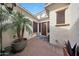 Private courtyard with a potted palm tree, tile flooring, and a cozy seating area at 3521 N Hooper St, Buckeye, AZ 85396