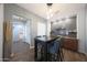 Stylish dining area featuring a built-in bar, sleek table and access to hall at 3521 N Hooper St, Buckeye, AZ 85396