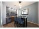 Stylish dining area with built-in bar, beverage center and sleek pendant lighting at 3521 N Hooper St, Buckeye, AZ 85396