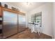 Kitchen nook with table seating next to stainless steel refrigerator and wood-look flooring at 3521 N Hooper St, Buckeye, AZ 85396