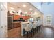 Bright kitchen featuring a breakfast bar with seating, stainless steel appliances, and wood-look flooring at 3521 N Hooper St, Buckeye, AZ 85396