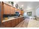 Spacious kitchen showcasing wood cabinets, granite countertops, and modern stainless steel appliances at 3521 N Hooper St, Buckeye, AZ 85396