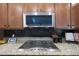 Kitchen with granite countertops, a stainless steel microwave, and a gas stovetop at 3521 N Hooper St, Buckeye, AZ 85396