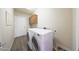 Laundry room with washer and dryer, overhead storage, and neutral-toned walls at 3521 N Hooper St, Buckeye, AZ 85396