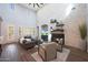 Bright living room with a fireplace, high ceiling, an open floor plan, and wooden accents at 3521 N Hooper St, Buckeye, AZ 85396
