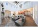 Bright living room featuring an open floor plan, high ceilings, and a cozy fireplace with modern finishes at 3521 N Hooper St, Buckeye, AZ 85396