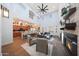 Spacious living room with a fireplace, high ceiling, and open access to the kitchen and dining area at 3521 N Hooper St, Buckeye, AZ 85396