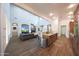 Open-concept living room and kitchen with a brick fireplace wall, creating a warm and inviting atmosphere at 3521 N Hooper St, Buckeye, AZ 85396