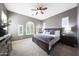 Serene main bedroom featuring soft lighting, a ceiling fan, and shuttered windows for privacy at 3521 N Hooper St, Buckeye, AZ 85396