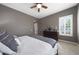 Bright and relaxing main bedroom with a ceiling fan, shuttered windows, and stylish decor at 3521 N Hooper St, Buckeye, AZ 85396