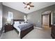 Comfortable main bedroom with neutral colors, a ceiling fan, and shuttered windows creating a relaxing space at 3521 N Hooper St, Buckeye, AZ 85396